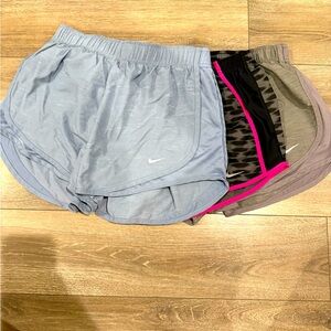 Medium Nike shorts. 3 pairs. Blue gray, black with pink, and a gray pair.